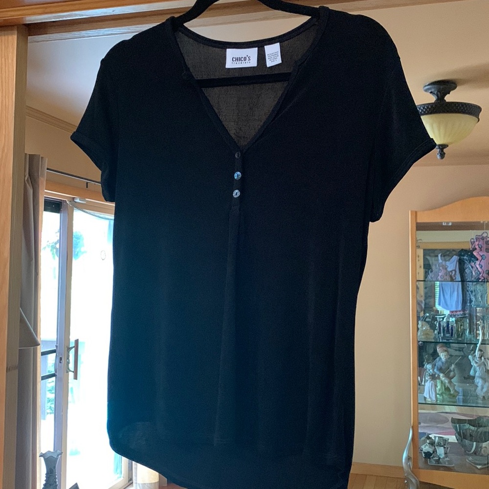 Chicos travelers black short sleeved v neck with 3 shell buttons.